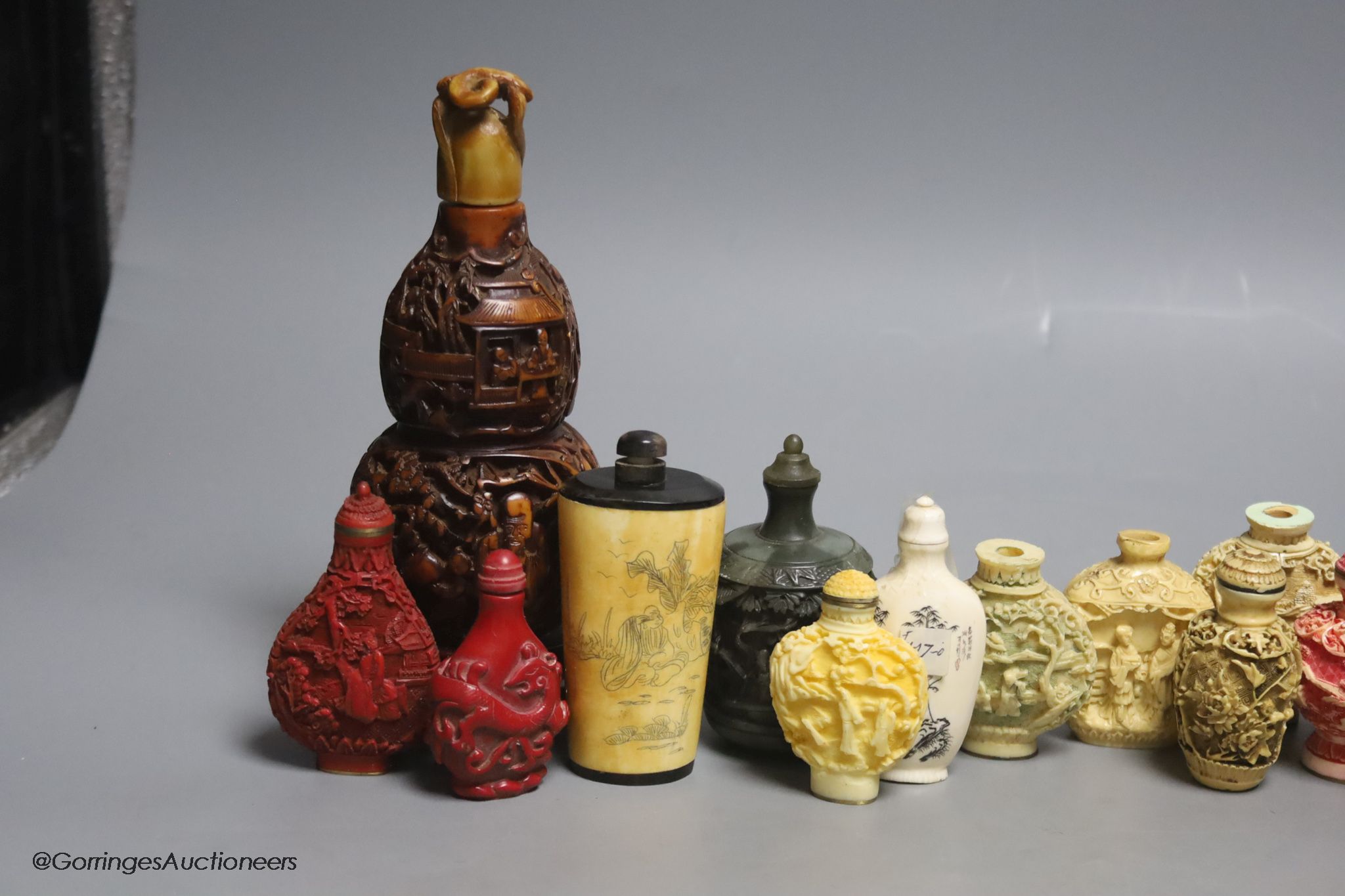 A large Chinese 20th century carved snuff bottle and smaller snuff bottles